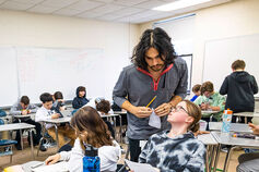 A male teacher works with elementary school students in South Bend, Indiana.